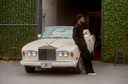 Man in Black Polo by Rolls Royce Car